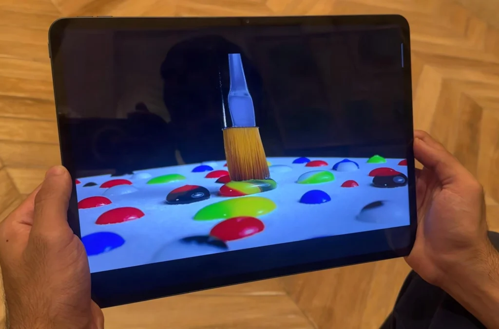 OnePlus Pad 3 Review (After Long Term Test) OnePlus Pad 3 tablet displaying a colourful video while held in landscape orientation